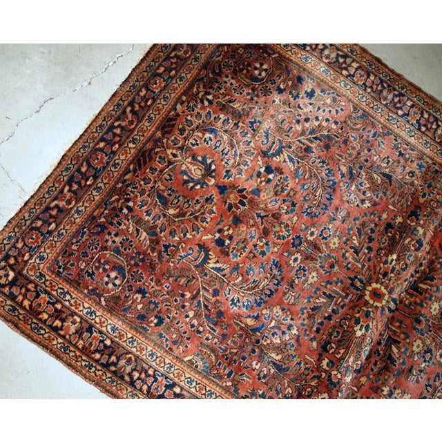 Hand-weaved antique Sarouk rug from the beginning of 20th century. The rug is in original good condition, made in classic...