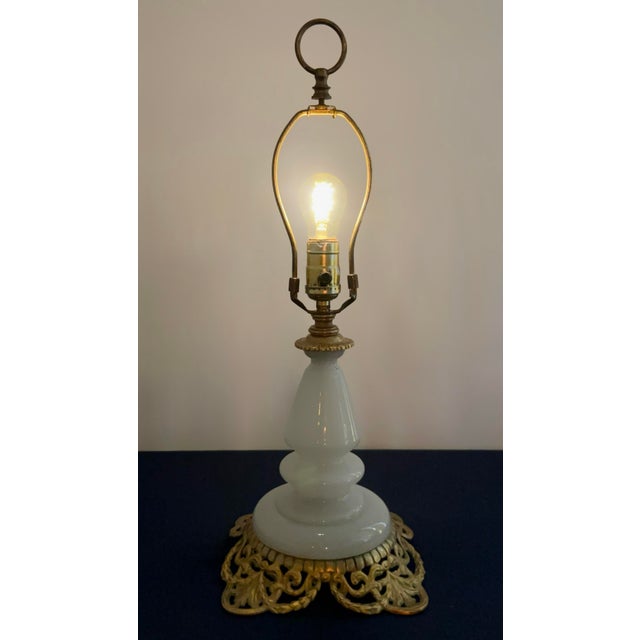 An exceptional mid-century Hollywood Regency accent lamp featuring a sculptural, tiered opaline milk glass column that...