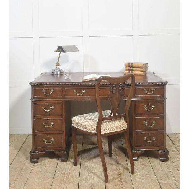 This distinguished mahogany twin-pedestal desk exemplifies refined traditional craftsmanship, offering both decorative...