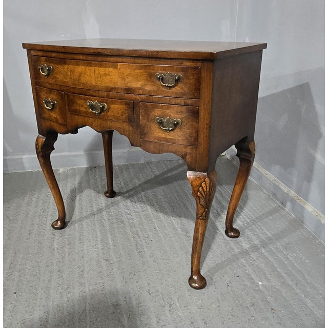 A very nice Queen Anne style burr walnut bowed low boy with four drawers, original brass handles, oak lined throughout, in...