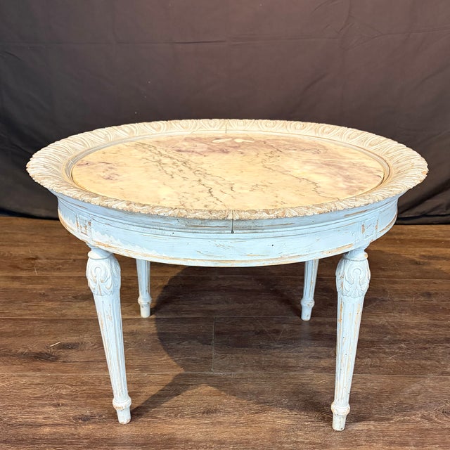 Louis XVI French antique coffee table with a beautifully veined Carrara marble top with just a hint of natural purple, all...