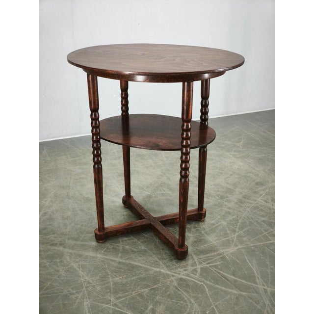 Elegant art deco oval side table produced in czechoslovakia during the 1920s. Crafted from beech wood and beech plywood,...