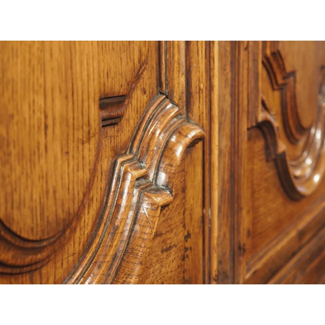 Hand-carved in France, circa 1700, this exceptional oak buffet deux corps offers ample storage space with eight doors, two...