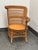 Design Plus Gallery presents a Vintage Woven Rattan Armchair. It has a rounded barrel-style back and integrated rolled...