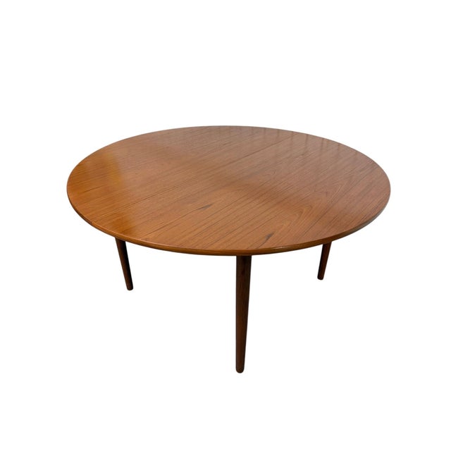 Elevate your dining space with this rare Danish Modern teak dining table designed by the legendary Hans J. Wegner....