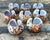 Elevate your next alfresco dinner or coastal-themed gathering with this exquisite set of eight vintage Tiger Cowrie shell...