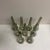 A set of nine smoked glass tapered hurricane style chandelier shades that stand.9.5" H x 1.5"D at top x 3"D opening at...