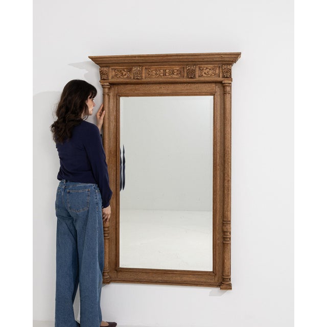 This mirror makes its impression through natural honey oak, turned column. The piece dates to 1900s, sourced from France,...