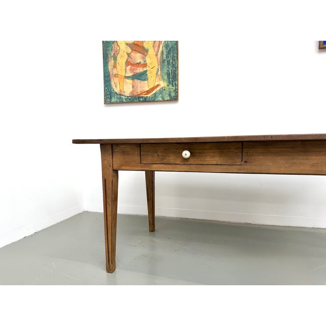 Maison lecan presents this solid pine farmhouse table, made in france in the 1950s. The wide pine plank top, with its dark...