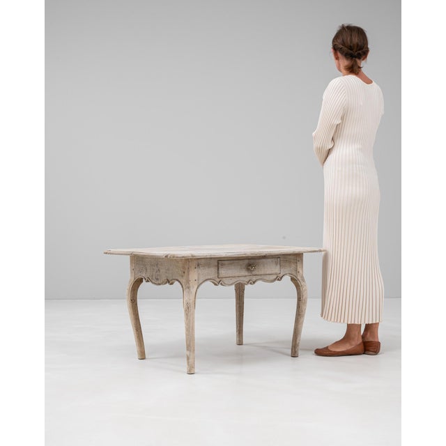 This 19th century French oak coffee table embodies the elegance of provincial design with its gracefully curved legs,...