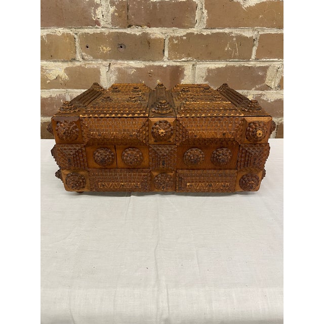 A striking example of American folk art craftsmanship, this antique Tramp Art lidded box features intricate, multi-layered...