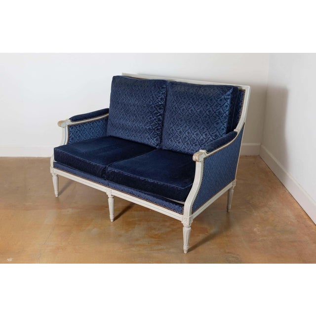 This 19th-century French Louis XVI-style sofa epitomizes elegance and timeless craftsmanship. The carved wood frame,...