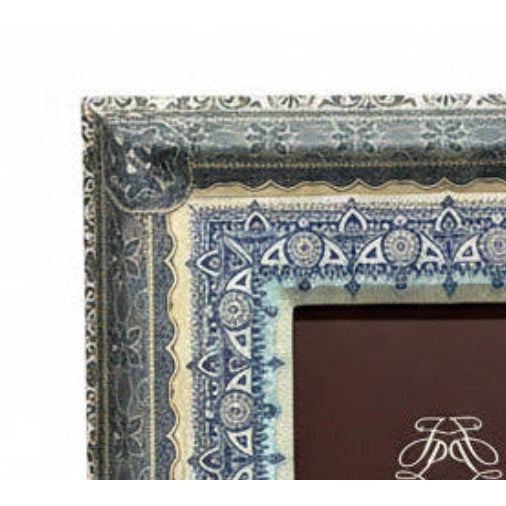 Wooden frame featuring an intricate decorative paper overlay that creates a visual aesthetic reminiscent of traditional...