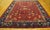 A striking antique red Chinese Art Deco, hand-knotted in wool in China around 1900. This one-of-a-kind piece showcases an...