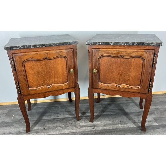 Elegant Vintage Charm. This handsome pair of vintage French bedside cabinets brings together graceful curves, rich oak...