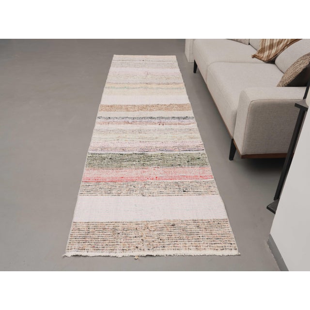 Vintage Hand-Knotted runner rug is a semi-antique vintage kilim runner rug. The '70s Eastern region of Anatolia's unique...