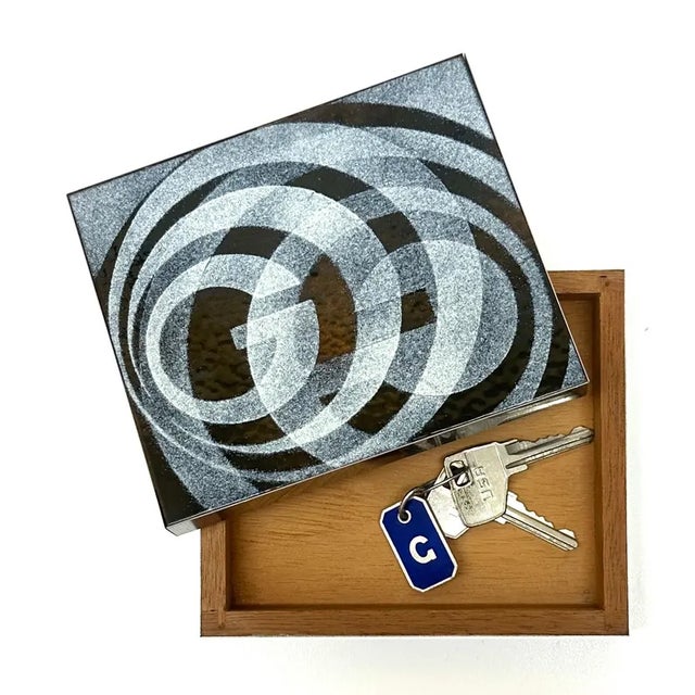 This is a rare vintage, handmade wood inlay and metal jewelry or trinket box featuring a striking circular black-and-white...