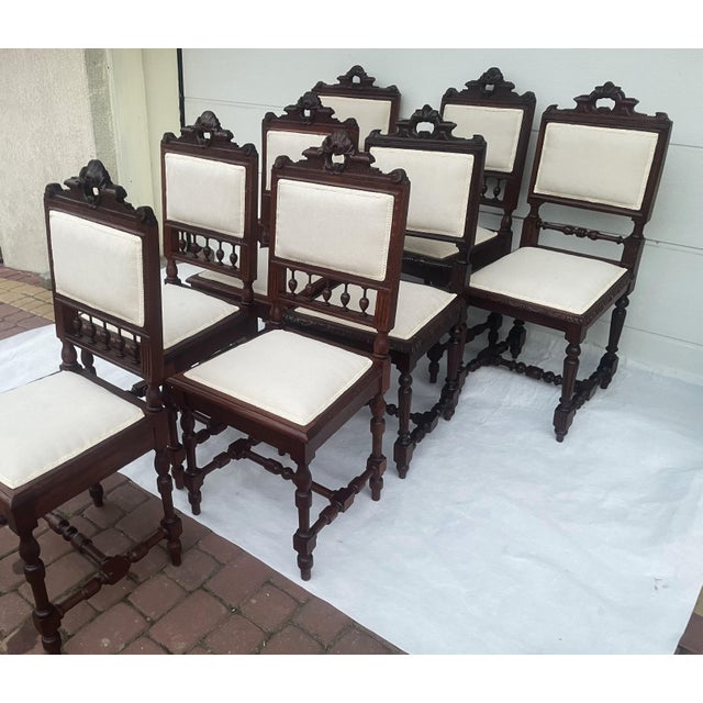 A set of eight original chairs made of solid oak, representing the Neo-Renaissance style from the turn of the 19th and...
