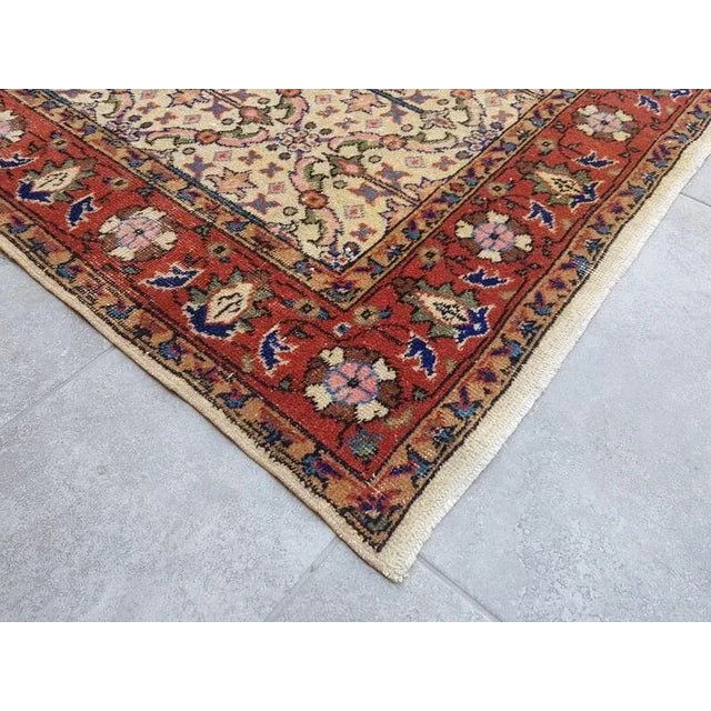 This is a vintage Turkish Oushak rug from the 1960s. The piece was hand-knotted.