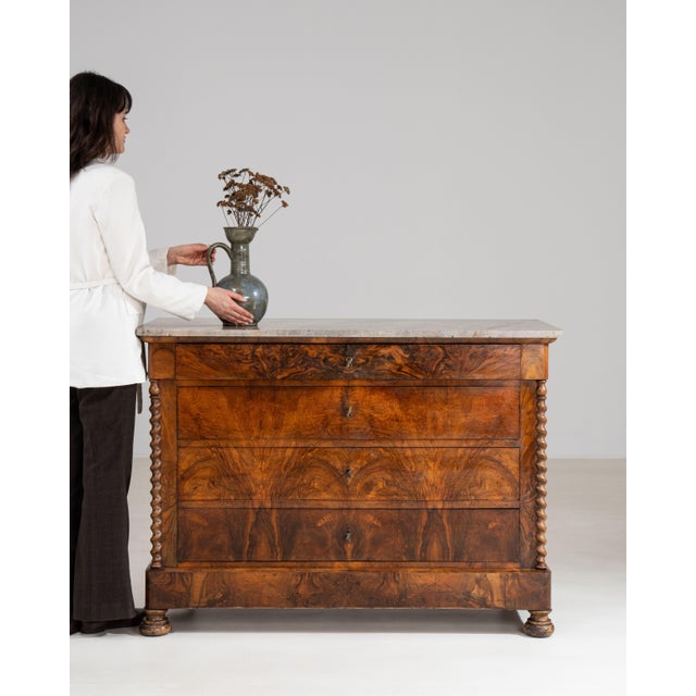 A refined Biedermeier chest of drawers characterized by clean lines, balanced proportions, and understated elegance. The...