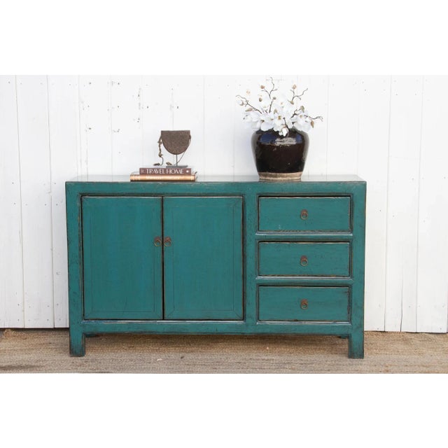 Chinese lacquered teal buffet – a perfect blend of timeless elegance and practical functionality. This lovely credenza...