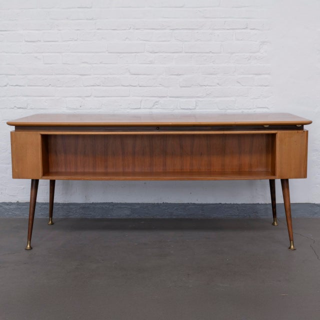 A representative desk in the spirit of Mid-Century Modern design This elegant desk from the 1950s combines flowing lines,...