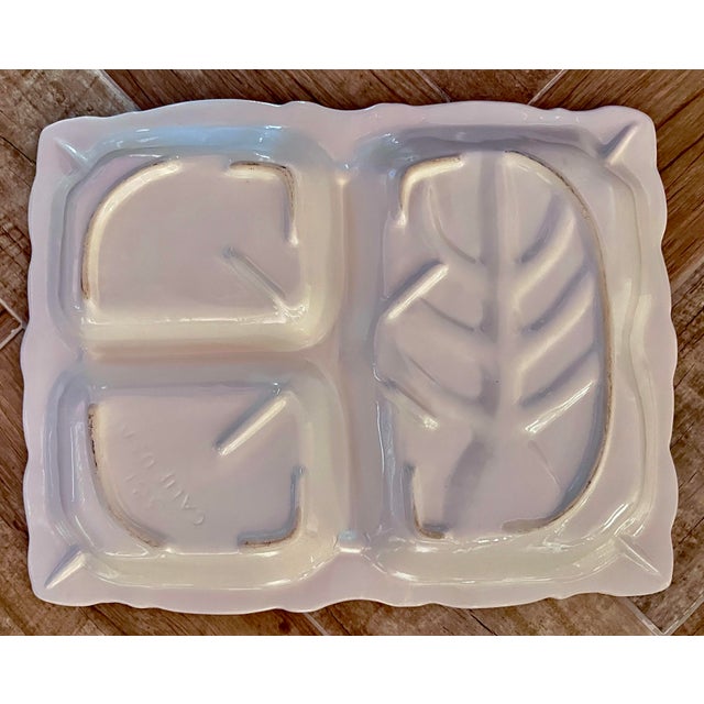 This vintage California Pottery serving platter features a solid white ceramic design with three compartments, perfect for...