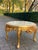 A refined 1960s French Louis XVI-style coffee table, crafted from solid beechwood with a luminous gilded finish and a...