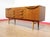 This Mid Century Modern Vintage British Teak Sideboard Credenza in the manor of Beautility embodies a beautiful classic...