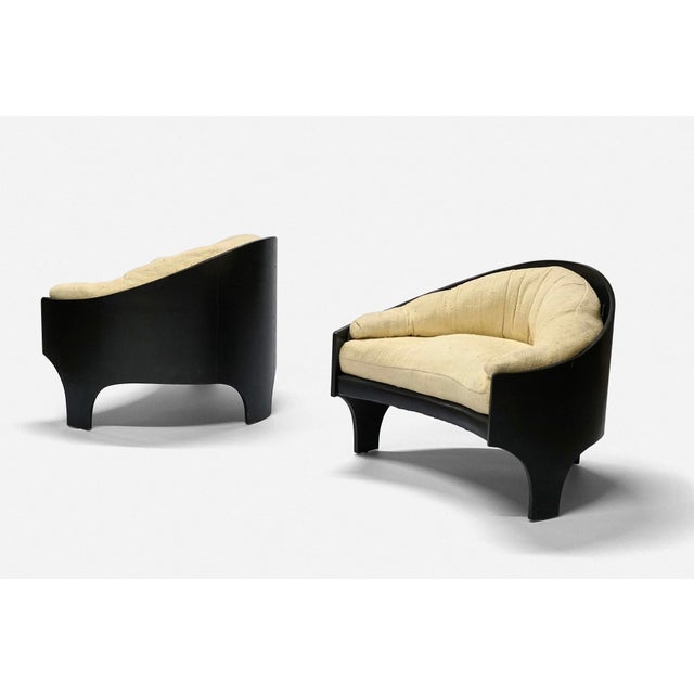 A pair of Henry P Glass intimate island lounge chairs Ebonized wood with upholstery Circa 1966 31.5D x 39W x 32H inches...