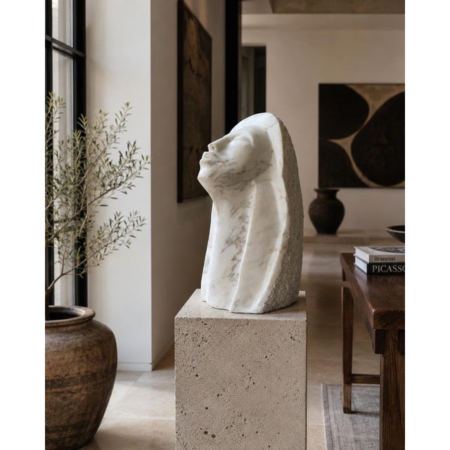 Striking 1980s vintage female bust sculpture hand-carved from solid white marble with natural gray and warm-toned veining....