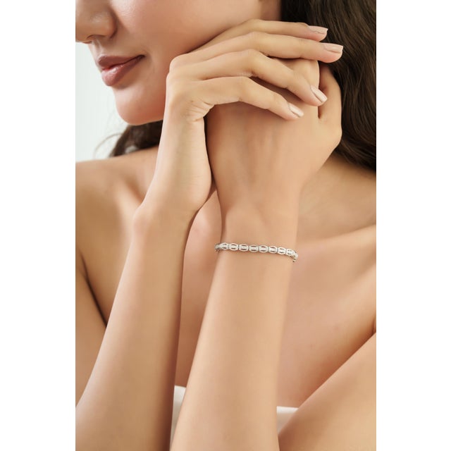 This Luxury Round-Cut Diamond Tennis Bracelet brings timeless elegance to a refined, contemporary silhouette. Crafted in...
