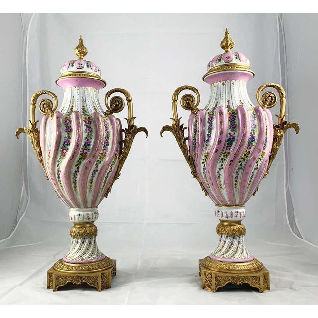 A fine pair of sevres porcelain two handled vases and covers with ormolu mounts. 19th century. Each with spiral lobed...