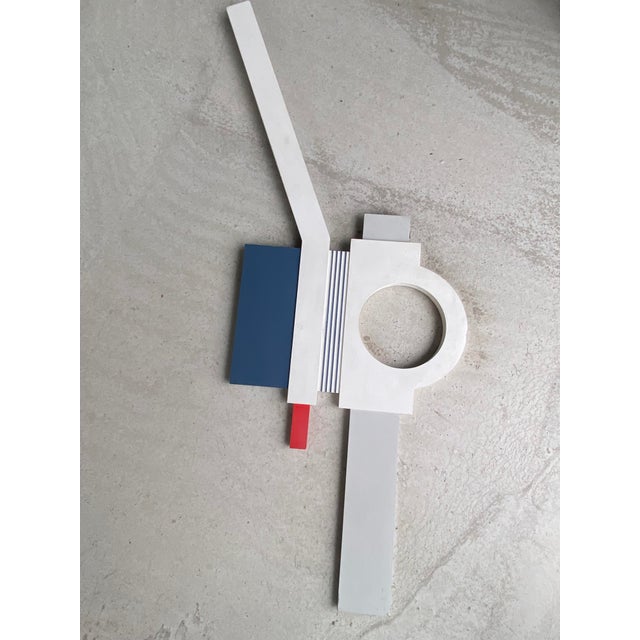 This sculptural work evokes a modernist aesthetic, blending geometry and abstraction. Dominated by rectangular and...