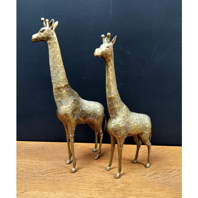 Cute pair of cast brass giraffes with stylized spots, made circa 1970's. Taller of the pair measures: 18.5" high x 9" deep...