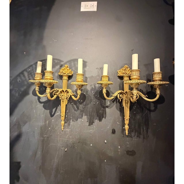 Circa 1900 Caldwell gilt bronze sconces with flowers design on top, 3 lights