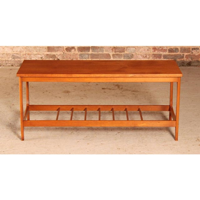 Mid Century teak coffee table with a magazine rack, circa 1960s. Fully restored. W 106cm D 40cm H 46cm