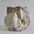Organic hand formed vase have different scalloped edged detailing. Scratched and molded onto the surface are layers of...