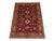 This naturally dyed wool Kazak rug has a rich purple field filled with rows of stepped medallions. Ivory, navy, gold, and...