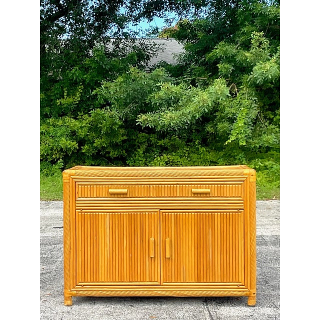 Golden gorgeous split bamboo credenza with swirl detailed trim around the edges. Add glamor and amazing storage to any...