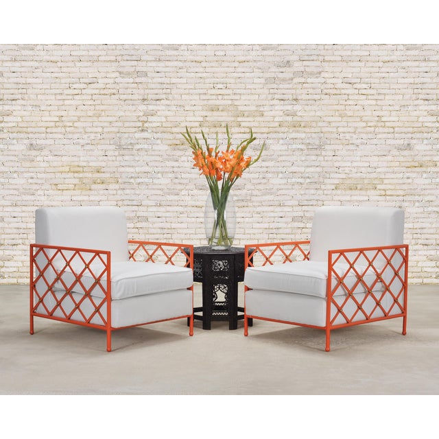 A striking pair of French mid-century modern iron and brass garden or patio lounge chairs in the manner and style of...