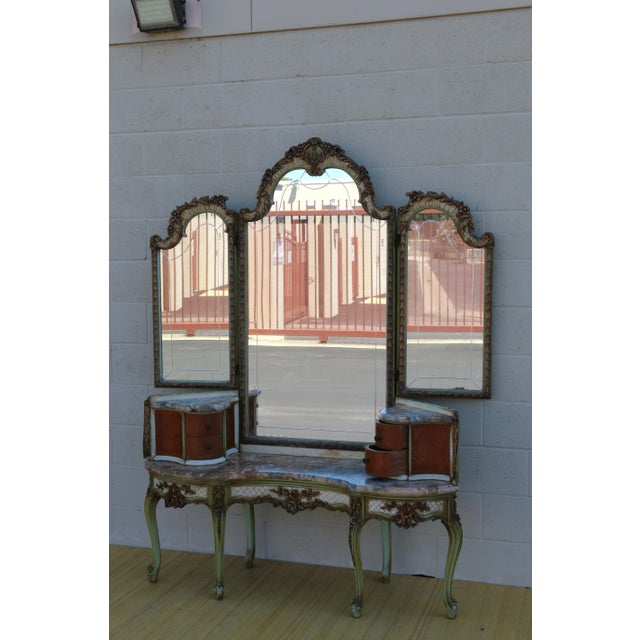 Spectacular antique French vanity with three folding panels mirror and two cabinets, two drawers in each one. Also, it has...