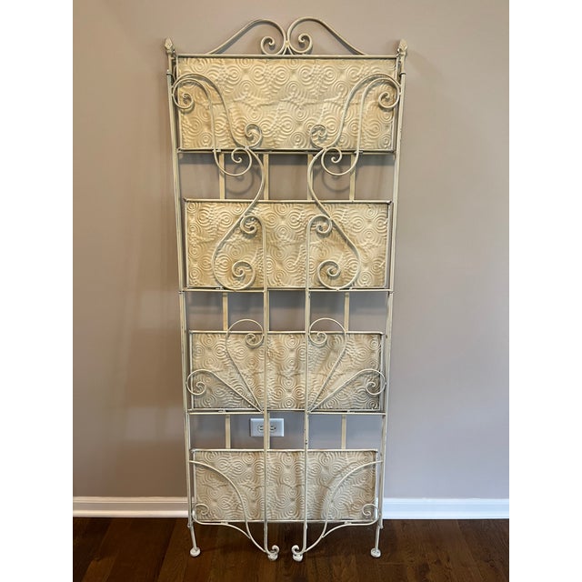 Ivory metal folding etagere is perfect for plants, books, cookware or for linens and towels. Four shelves are 24” W x 10”...