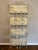 Ivory metal folding etagere is perfect for plants, books, cookware or for linens and towels. Four shelves are 24” W x 10”...