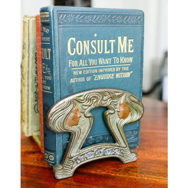 Antique brass and metal Art Nouveau book rack, stylized female figures on each end, adjustable up to 21 inches fully open...