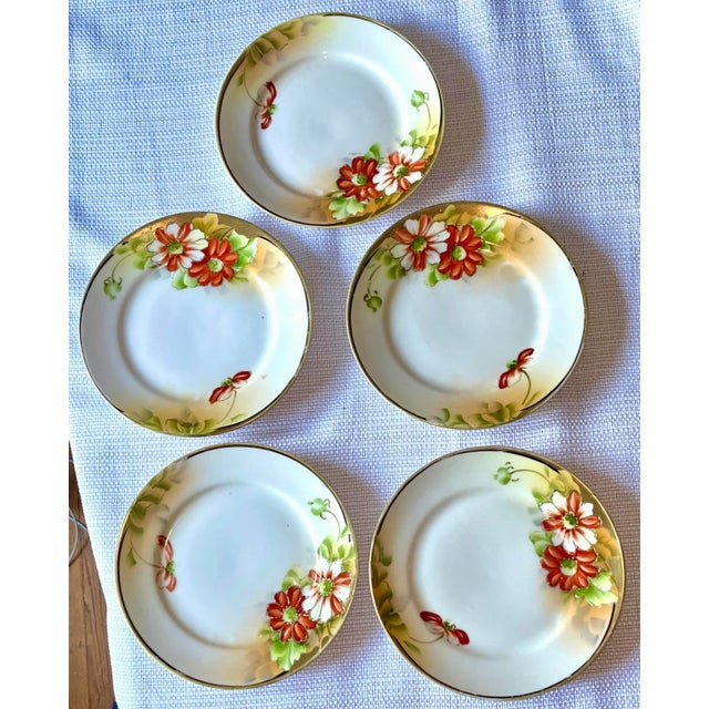 Set of Five (5) early 1900s Hand Painted Nippon porcelain plates. Beautiful poppies adorn these plates with raised gold...