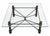 Vintage square coffee table with a textured, dark-patinated metal frame, turned legs, and intersecting stretchers joined...