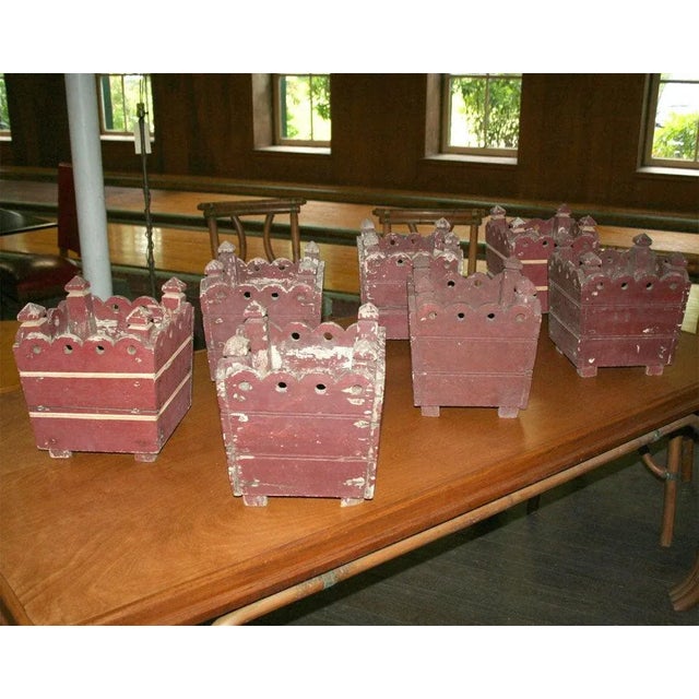 Four painted square wooden French planters with scalloped edge detail.