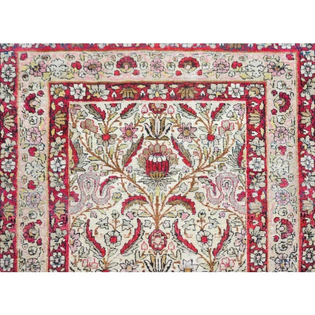 An incredible and rare early 20th century Persian Lavar Kirman runner with an unusual floral pattern containing scrolling...