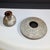 A distinctive pair of handmade studio art pottery vessels, both signed “MH,” showcasing colorful abstract decoration and...